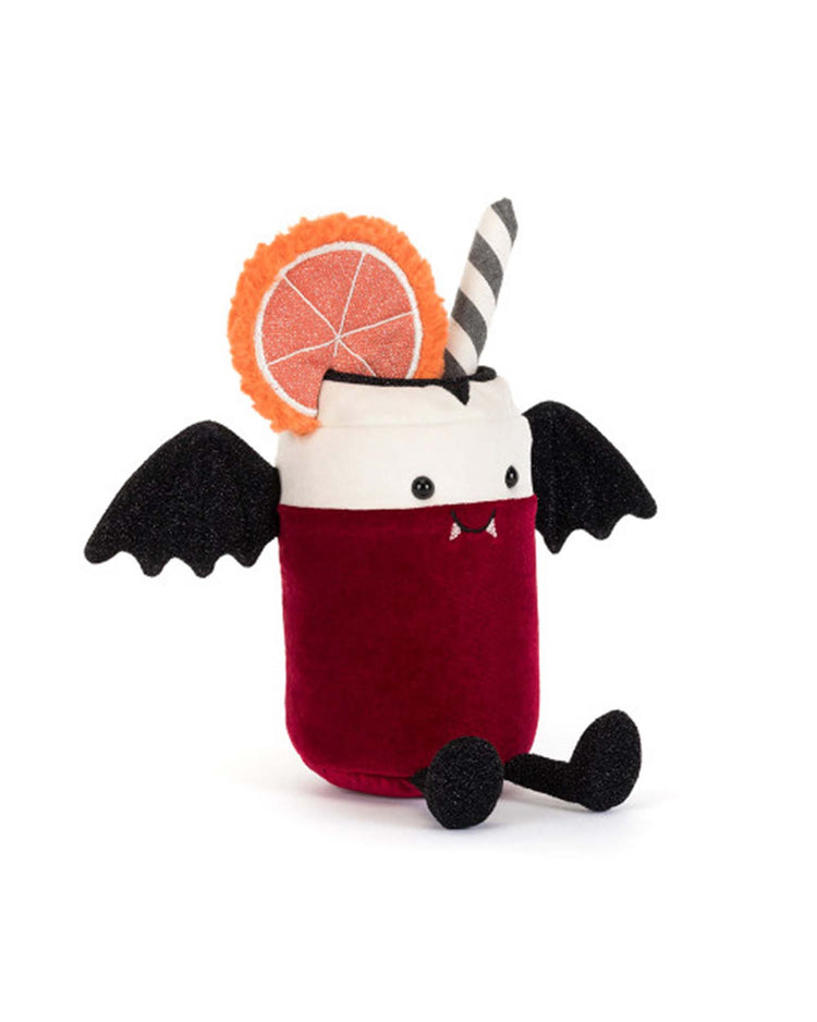The Jellycat Amuseables Vampop Drink is a whimsical Halloween plush toy shaped like a red drink with bat wings, black legs, white fangs, a striped straw, and an orange slice garnish.