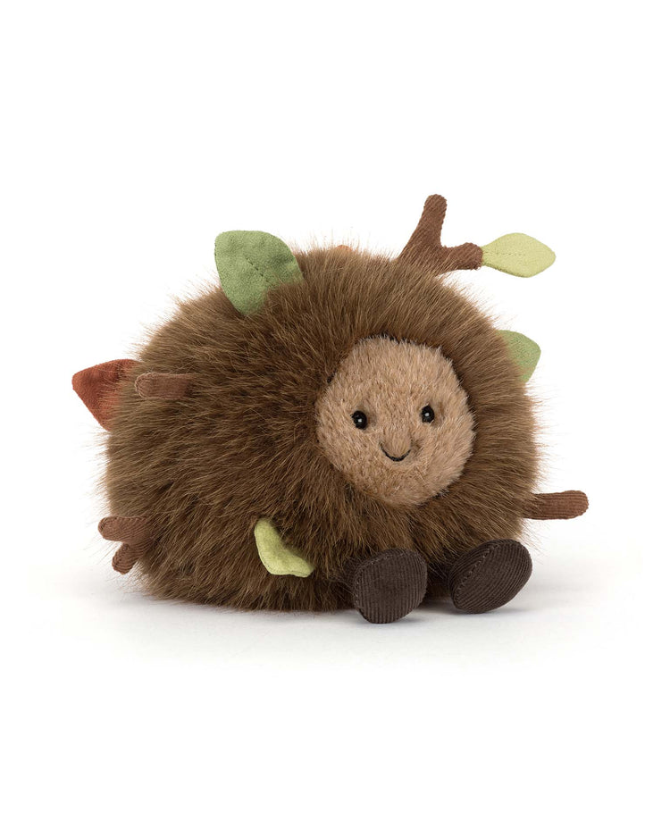 Jellycat’s Amuseables Mulshi Woodland Floor is a round, fluffy plush hedgehog with brown fur, a smiling beige face, small brown feet, and soft fabric leaves and twigs inspired by the woodland floor.
