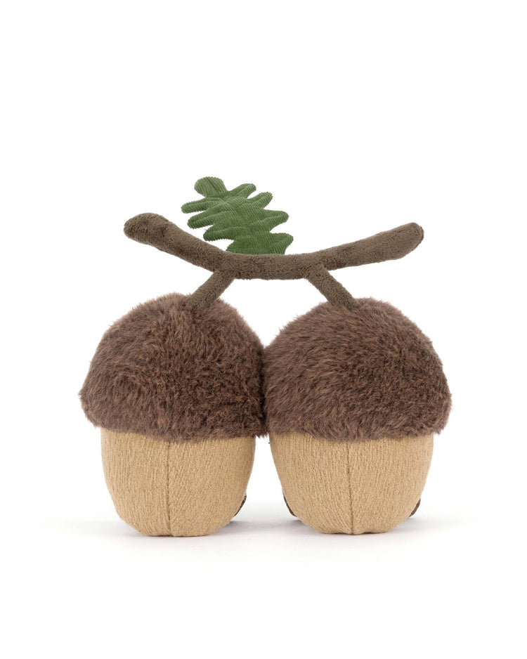 The Jellycat amuseables Ort & Tum Acorns feature two plush acorns with fuzzy brown tops, tan bottoms, a soft brown stem, and a green felt leaf—making this collectible stuffed toy a charming addition to any collection.