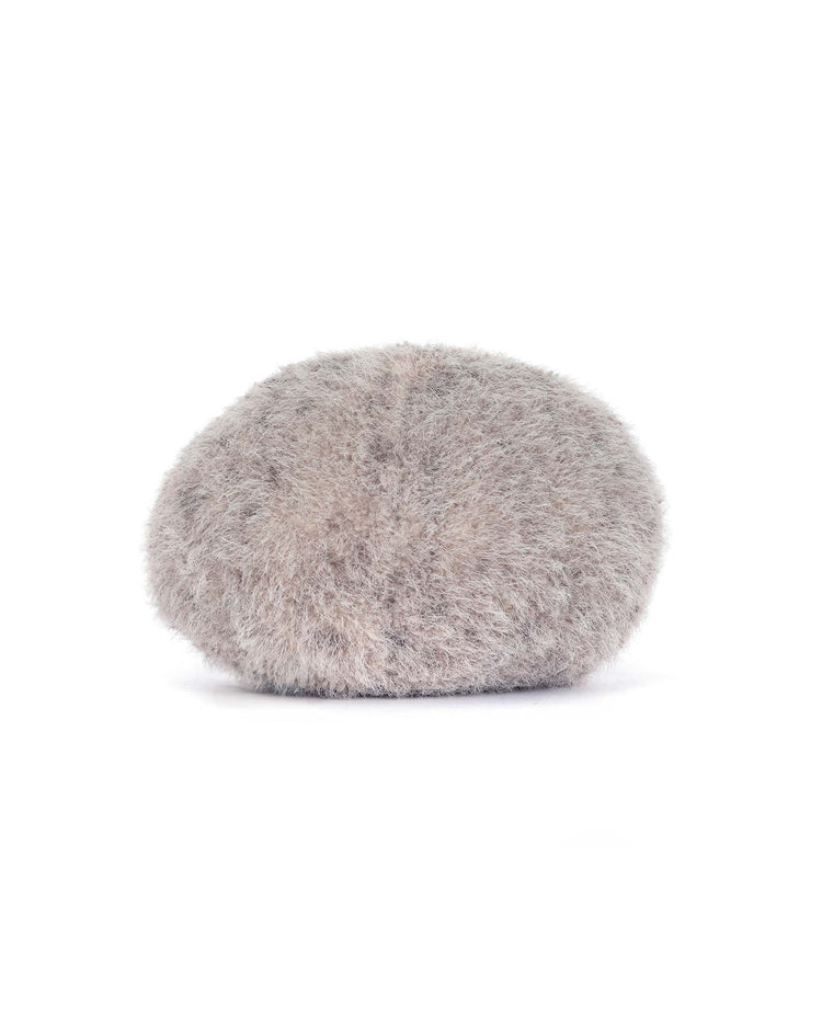 The jellycat amuseables pebble is a light grey, round, and fluffy beret hat with a soft, fuzzy texture, shown against a plain white background.
