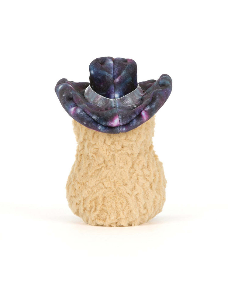 The Jellycat Amuseables Peanut Space Rodeo Outfit plush toy features tan, textured fur and is shown from the back wearing a purple and blue marbled cowboy hat with a light gray band against a plain white background.