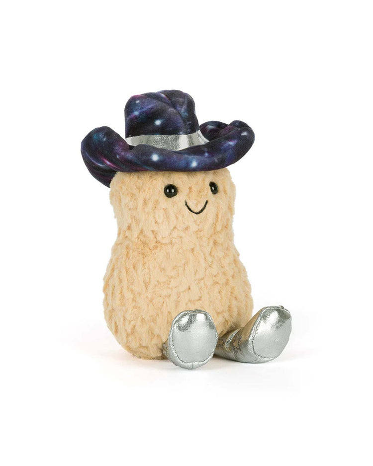 The Jellycat Amuseables Peanut wears a Space Rodeo Outfit with a shiny silver cowboy hat, purple galaxy pattern, and matching boots. This plush toy smiles cheerfully against a white background.
