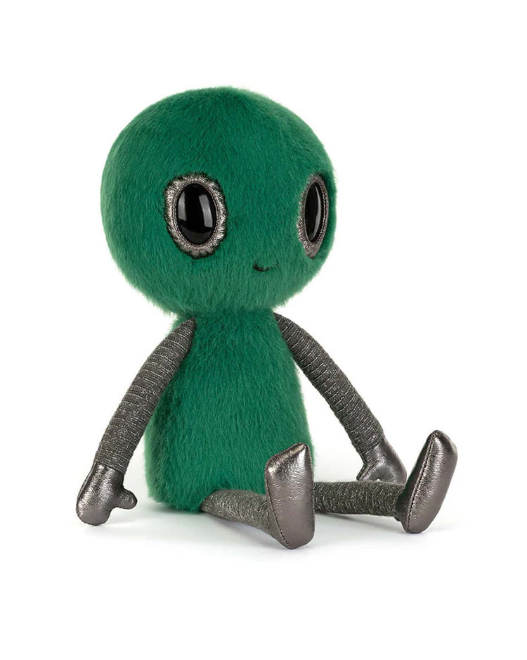The Jellycat Zyllan Alien is a plush toy with a round green fuzzy head and body, large black eyes, a small smile, and shiny metallic gray arms, legs, and feet. It sits upright against a white background.