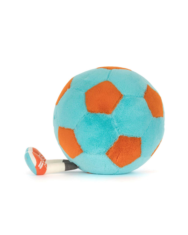 The amuseables jellycat soccer ball by Jellycat, with blue and orange panels, sits beside a plush whistle on a white background—a playful kids’ set from the Amuseables Sports collection.