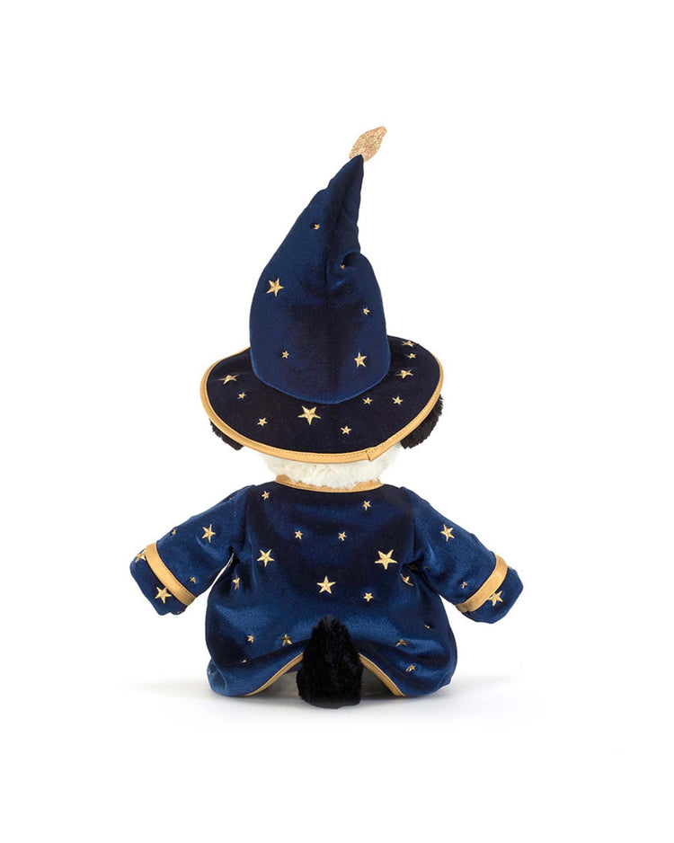 A Jellycat Rufferty Puppy Wizard Outfit plush toy, dressed in a blue wizard costume adorned with gold stars and trim—including a tall pointed hat and cape—is displayed from the back against a white background.