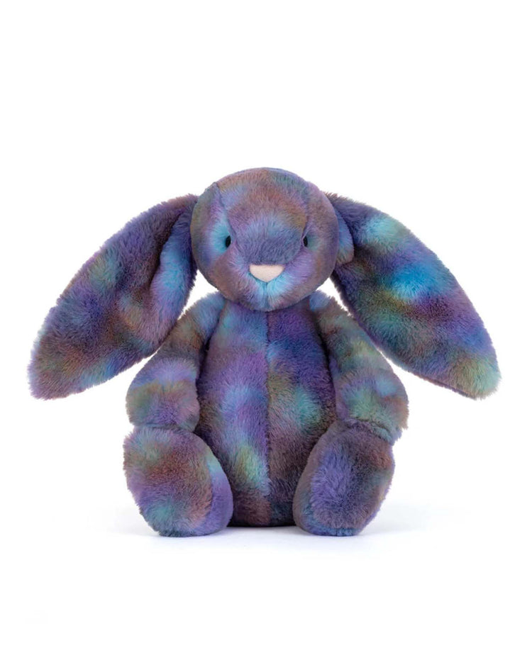 The jellycat zodihop luxe bunny features long floppy ears and soft, multicolored fur in purple, blue, and green—a cosmic-pattern plush toy perfect for space bunny lovers, shown sitting upright against a white background.