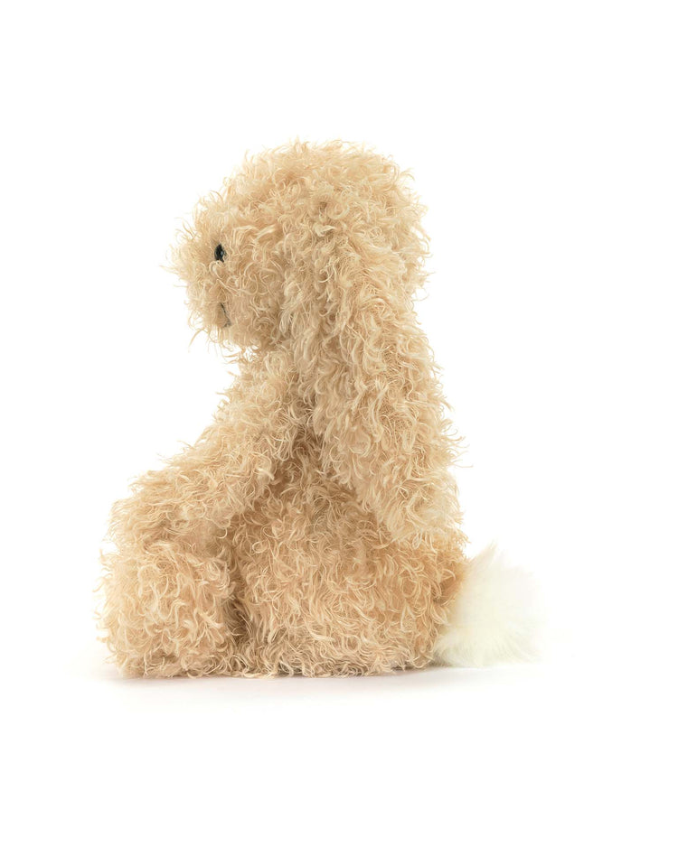 The jellycat bashful luxe bunny curly original is a beige plush with curly fur and a fluffy cream bobtail, pictured upright in profile against a white background—perfect for cuddling.