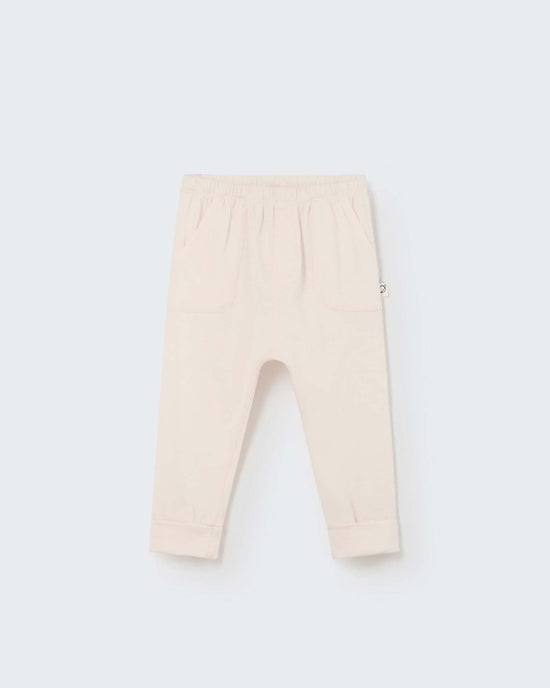Cairo baby pant in ivory by My Little Cozmo: Organic cotton children's pants with an elastic waistband and folded cuffs, inspired by European styles and crafted in Barcelona. Displayed on a plain background.