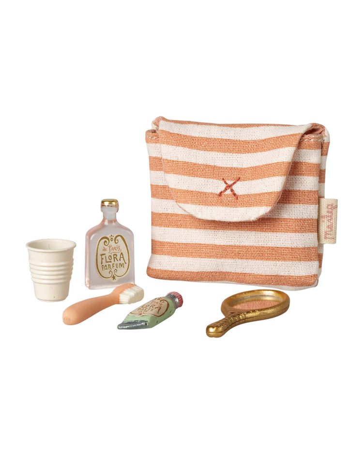 The "toothbrush set in bag, mouse - coral stripe" by maileg is a small striped fabric pouch with toy toothbrush accessories—perfect for your mouse family's bedtime routine playset.