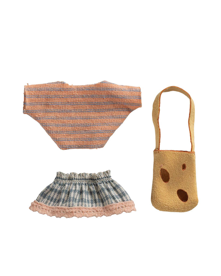 The maileg clothes and bag for little sister mouse includes a striped orange and peach top, a blue plaid skirt with pink frill, and a tan handbag—perfect accessories for dressing up your Little Sister Mouse.