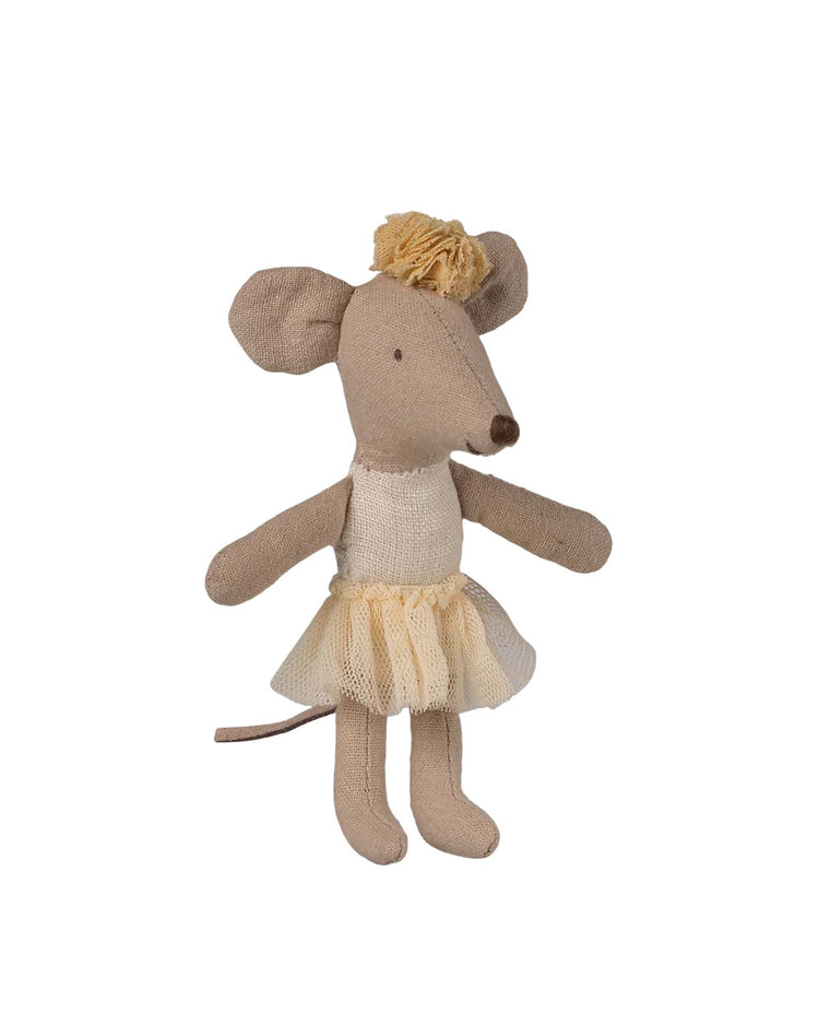 The Maileg little sister ballerina mouse in off white stands upright, wearing a charming cream tulle tutu and matching headband, with a light brown body and large round ears on a white background.