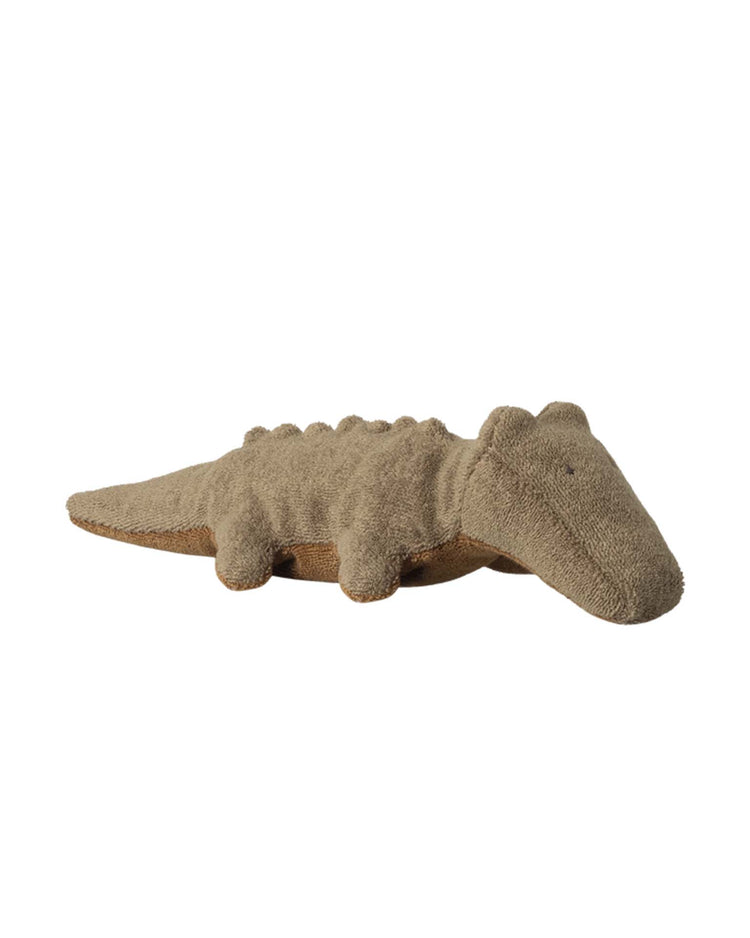 The maileg mini crocodile in olive green, part of the safari friends collection, is a soft and huggable stuffed animal with textured fabric and small legs, shown lying flat on a white background.