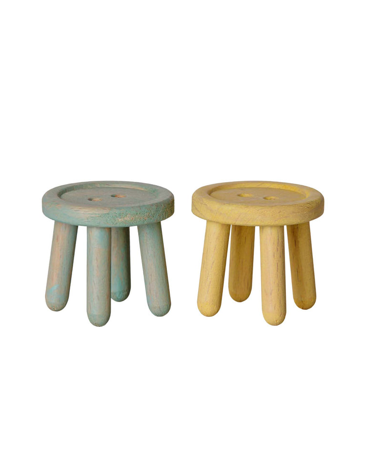 Featured in this charming Mouse Hole Farmhouse-inspired scene is the maileg stool set, mouse - mint/light yellow. The set includes two small, round wooden stools—one in a soft mint hue and the other in light yellow—each with four sturdy legs and a smooth, button-like top. Perfectly sized for little mice, these delightful stools are showcased against a plain white background.
