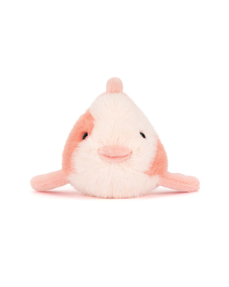 The jellycat fancy carp is a small plush toy with pink and white fur, tiny fins, black eyes, and a smiling mouth. It adds a touch of charm as a refined accent on an opulent sofa against a plain white background.