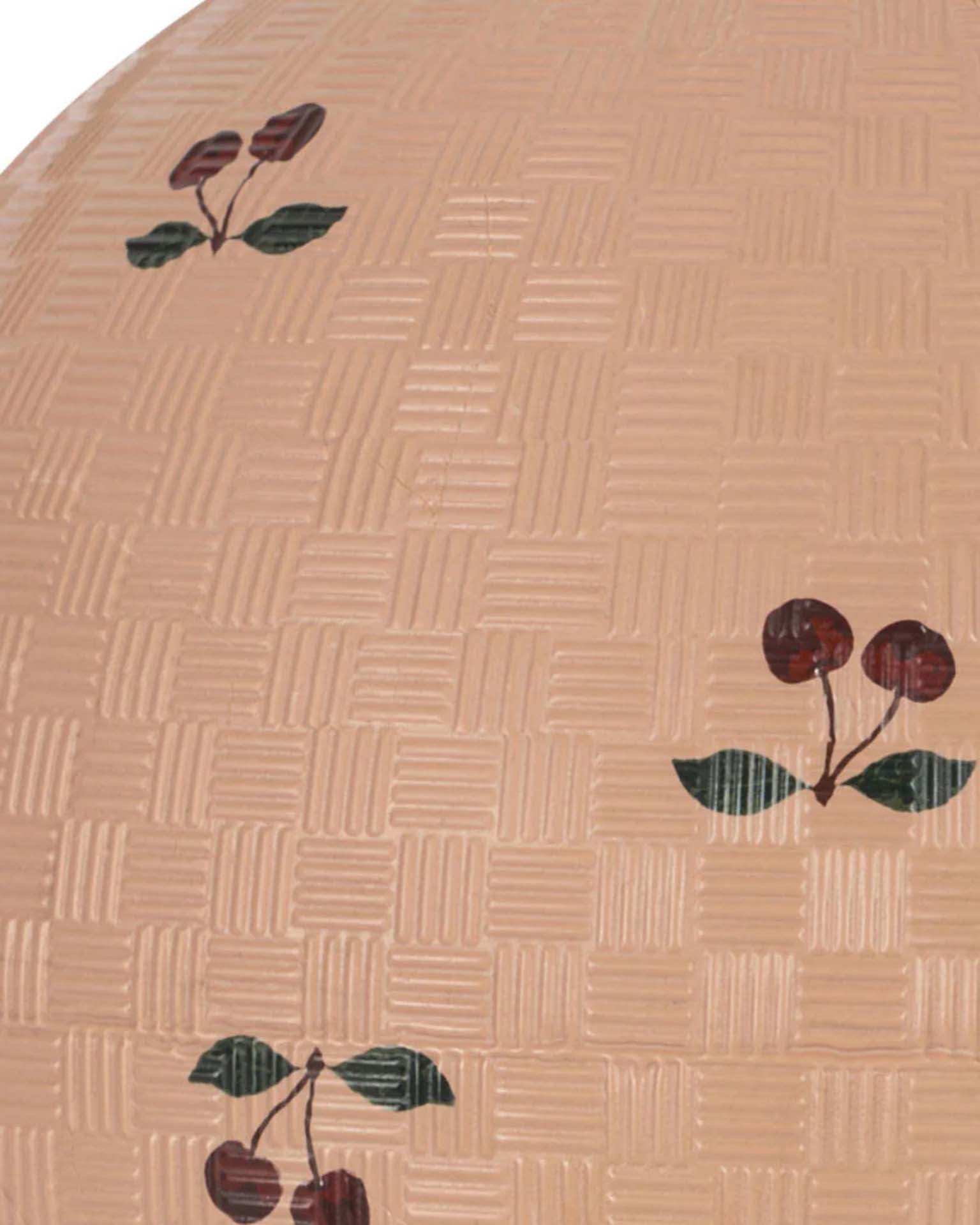 The konges sløjd kids ball in cherry blush features a tan, basket-weave texture decorated with painted cherry clusters and green leaves, evoking a playful outdoor toy for active games.