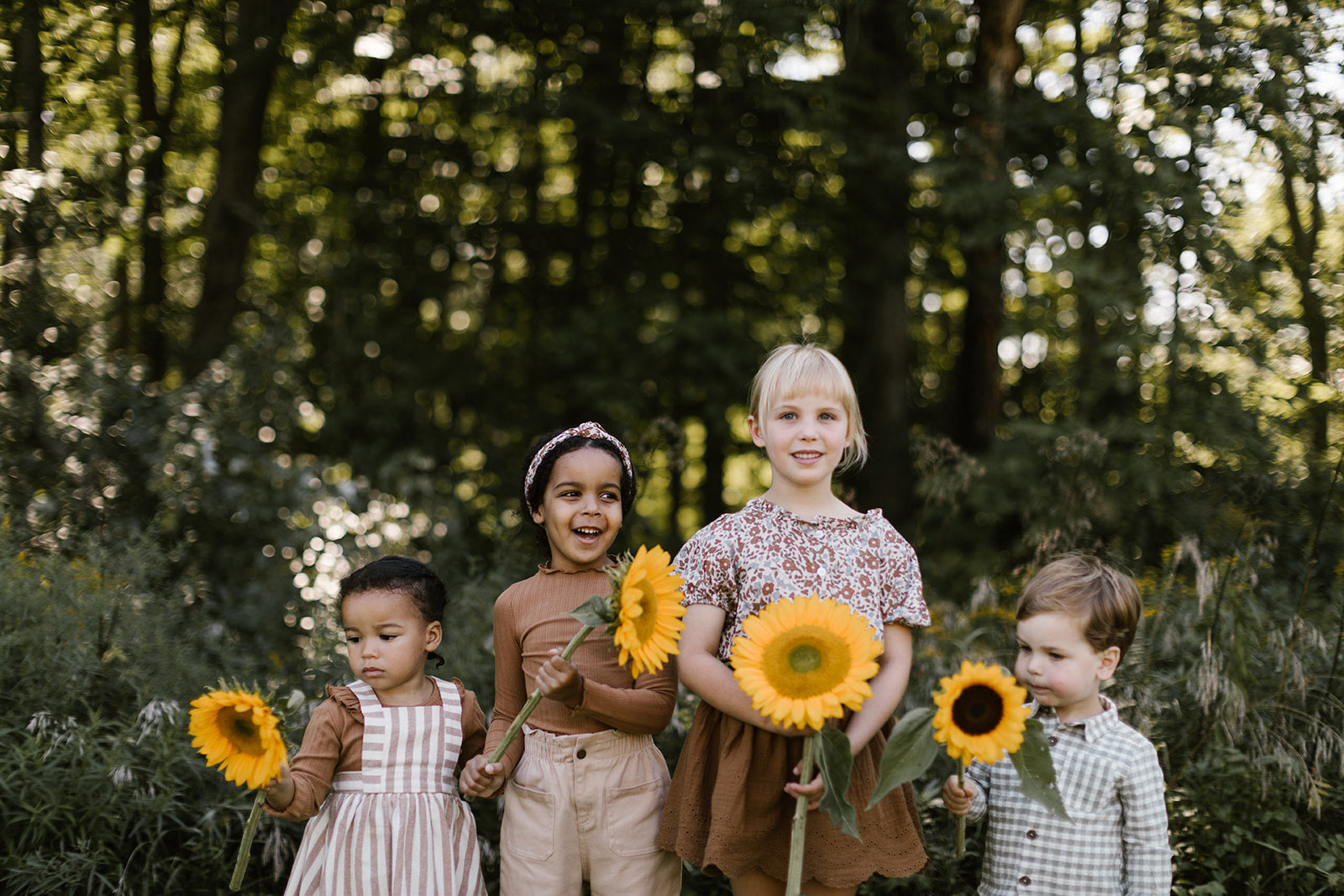 Kids holding sunflowers