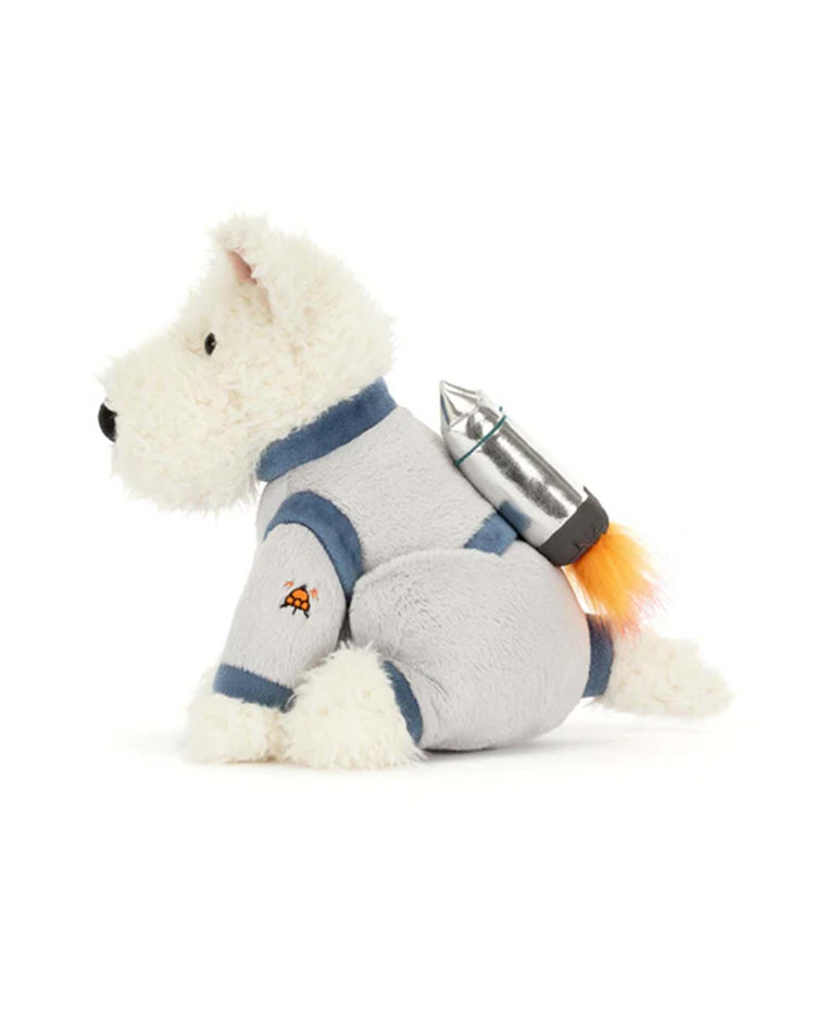 The jellycat munro scottie dog space outfit is a plush white dog toy in a gray and blue space suit with a rocket pack and embroidered rocket patch, finished with orange and yellow flame details for an out-of-this-world look.