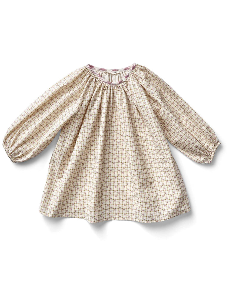 The peasant tunic in checker rose print by soor ploom is a charming, loose-fitting, long-sleeved baby dress crafted from cotton. With its colorful checkered pattern and gathered neckline, this adorable piece combines style and comfort effortlessly. Made in Portugal.