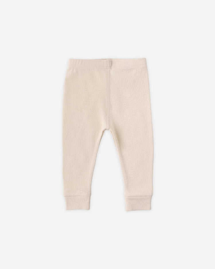 The quincy mae ribbed legging in ecru features stretchy rib knit fabric, an elastic waistband, and cuffed ankles, shown laid flat on a white background.