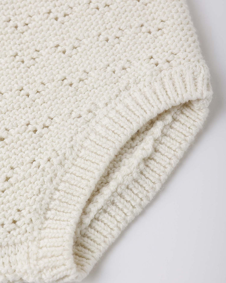 Close-up of the quincy mae knit bloomer in natural, featuring soft, organic cotton with a ribbed waist and a cozy pointelle pattern of small holes.