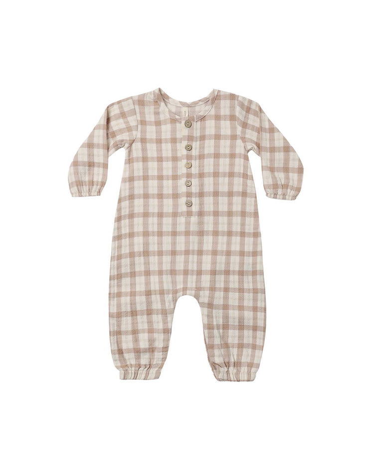 The quincy mae woven jumpsuit in rustic plaid, featuring beige and white tones, a button-up front, and elastic cuffs at the wrists and ankles, is laid flat on a white background.