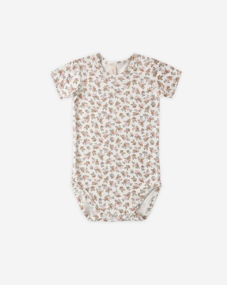 The quincy mae bamboo short sleeve bodysuit in wildflower features a white background with an all-over brown and pink floral print—ideal for creating a vintage nursery look.