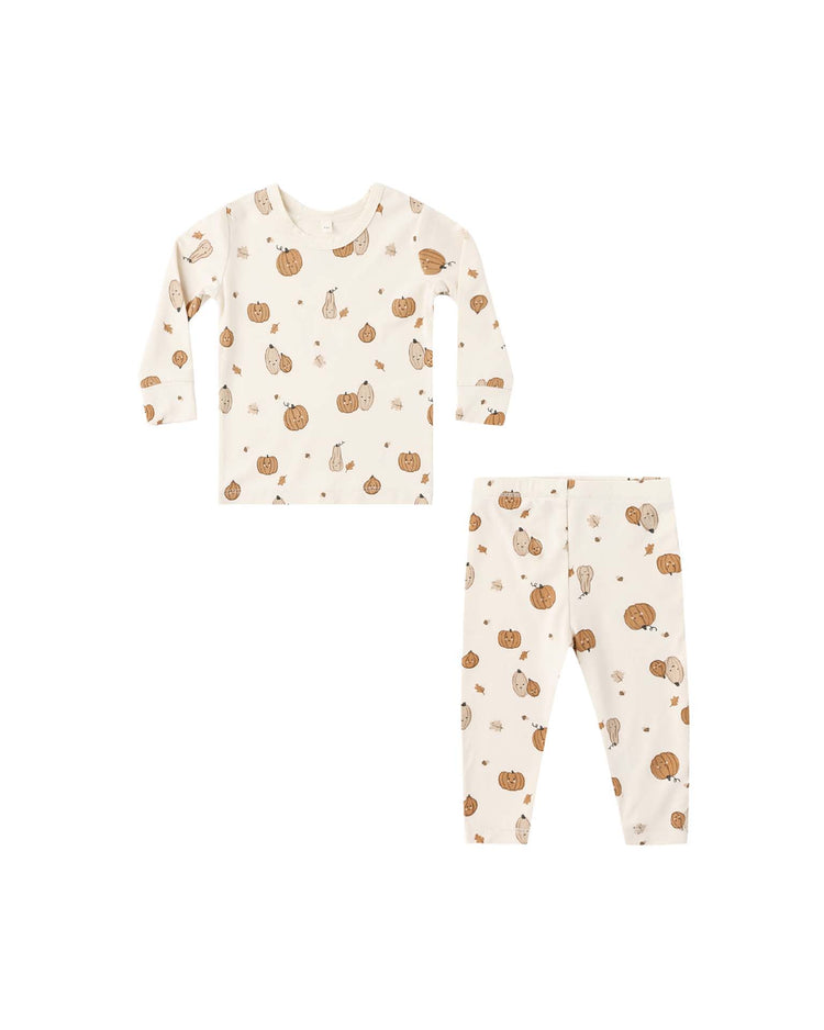 The quincy mae bamboo pajama set in harvest friends is a two-piece set that includes a long sleeve tee and leggings in cream, decorated with an all-over print of pumpkins and small animals in brown and beige tones, shown against a white background.