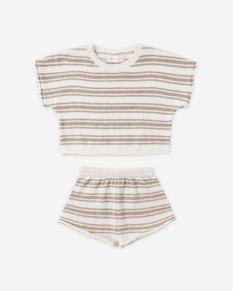 The quincy mae relaxed summer knit set in oat stripe features a short-sleeve dolman top and shorts in organic cotton, with beige and brown horizontal stripes on cream, shown laid flat on a white surface.