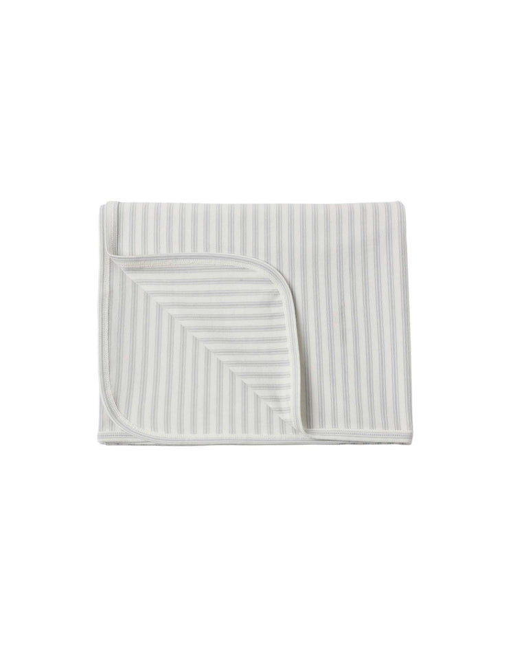 A folded swaddle in cloud stripe by quincy mae, featuring light gray vertical stripes on a white background with one corner turned up to display the other side. Made from soft organic cotton, this baby swaddle provides comfort and a modern, airy appearance.