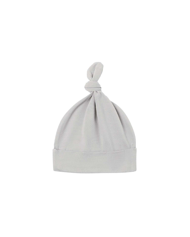 A bamboo knotted baby hat in the shade "cloud" by Quincy Mae, featuring a folded brim and a top knot, displayed against a plain white background.