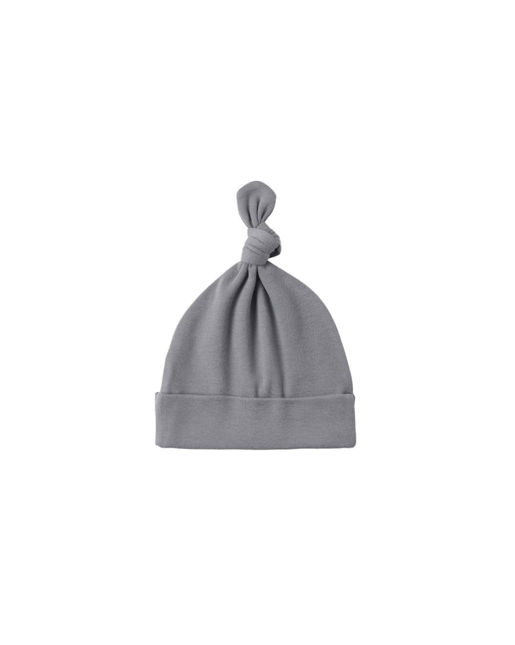The bamboo knotted baby hat in slate by quincy mae features a folded brim and top knot, crafted from luxurious bamboo fabric and shown against a white background.