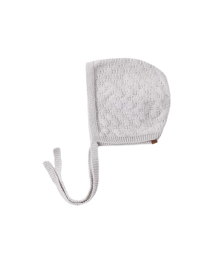 A knit bonnet in cloud by quincy mae, featuring a light gray hue and two ties, displayed flat on a white background.