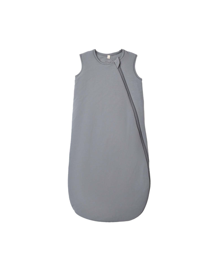 A bamboo sleep bag in slate by Quincy Mae, crafted from soft bamboo fabric with a sleeveless design, features a diagonal zipper from the neckline to the bottom right side and is rated 1.0 TOG for comfortable use throughout the year. The product is shown against a plain white background.