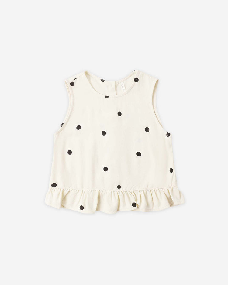 The rylee + cru oceanside top in polka dot is a sleeveless cotton blouse featuring black spots and a ruffled hem, perfect for summer. Shown on a plain white background.