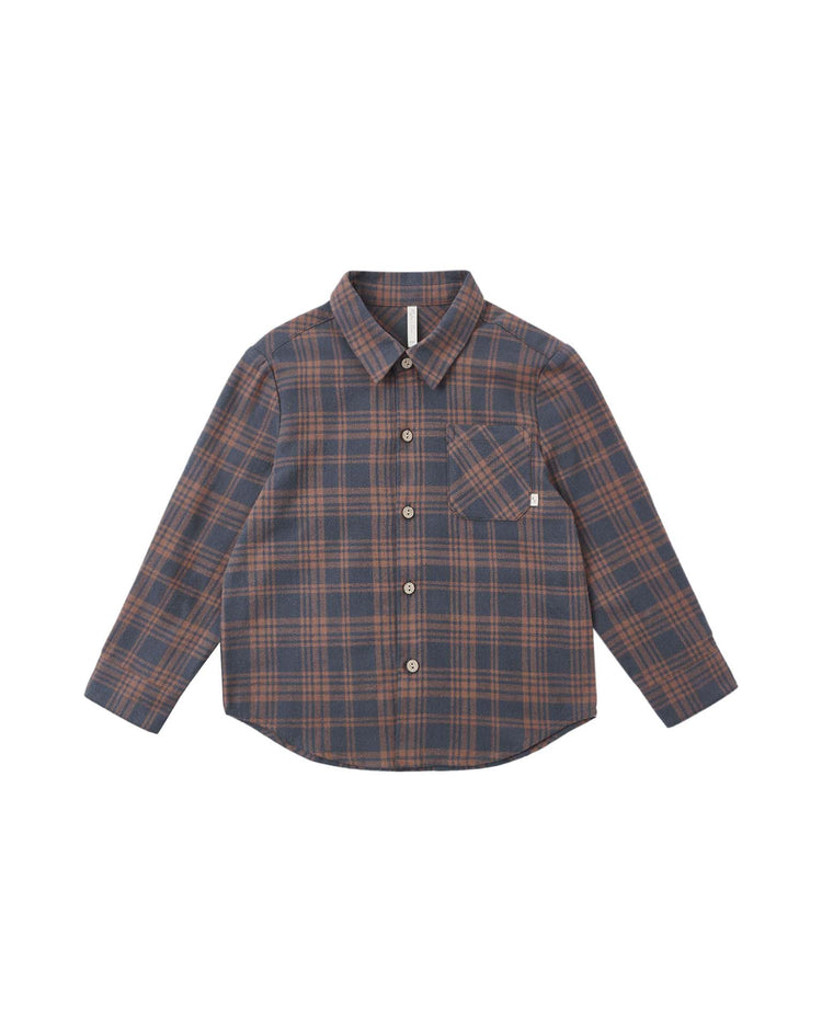 The “collared long sleeve shirt in midnight plaid” by rylee + cru is a button-up style featuring a blue and brown midnight plaid pattern and a single chest pocket on the left. Made from 100% cotton, the shirt is laid flat on a white background.