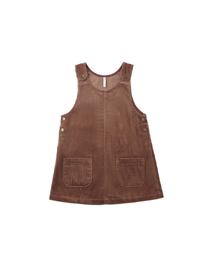Odette overall dress in mulberry by rylee + cru, crafted from 100% cotton corduroy in a rich brown hue, featuring front pockets and button details on the shoulders and sides, displayed laid flat on a white background.