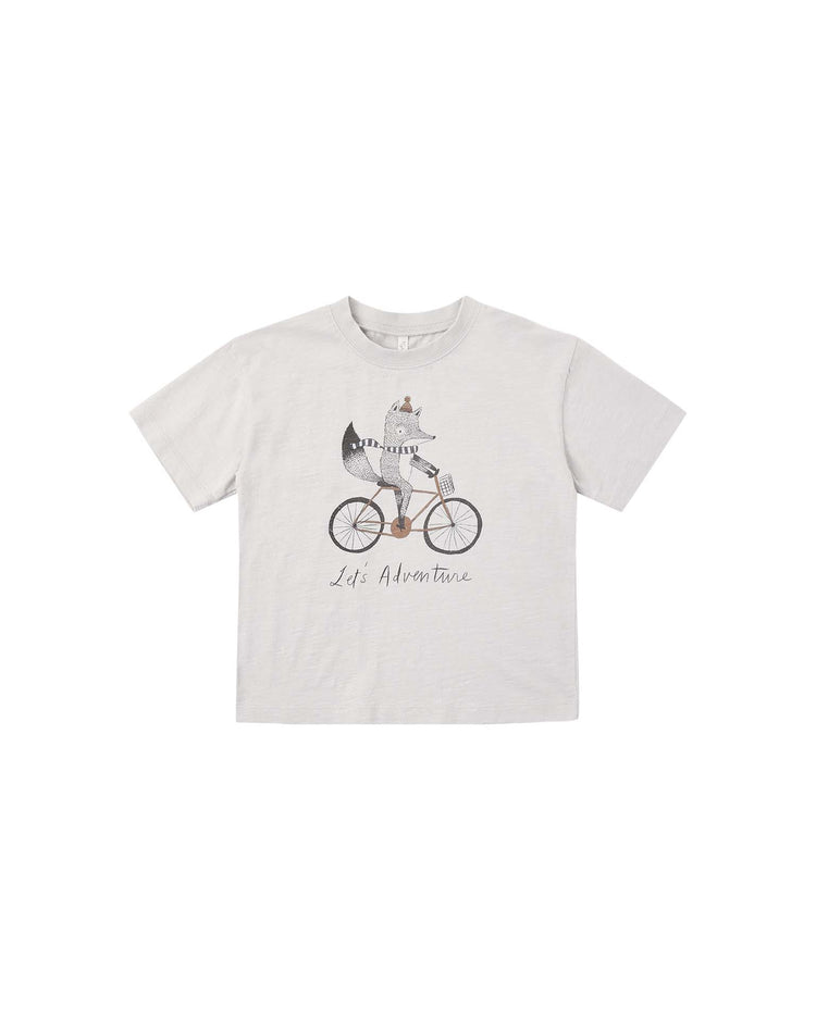 The PREORDER relaxed tee in let’s adventure by rylee + cru is a light gray cotton jersey t-shirt featuring an illustration of a raccoon riding a bicycle with the phrase “Let’s Adventure” printed beneath. This relaxed-fit top offers everyday comfort with its classic crew neck and short sleeves.