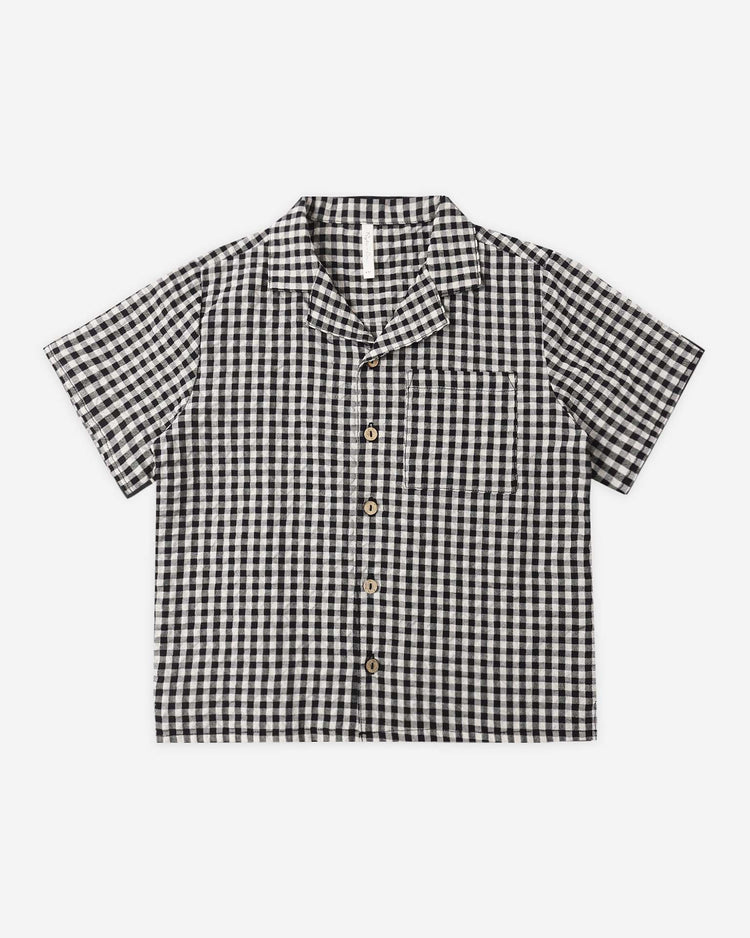 The lapel collared shirt in black check by rylee + cru is a boys’ short-sleeve button up with a classic check pattern, front chest pocket, and notched collar.