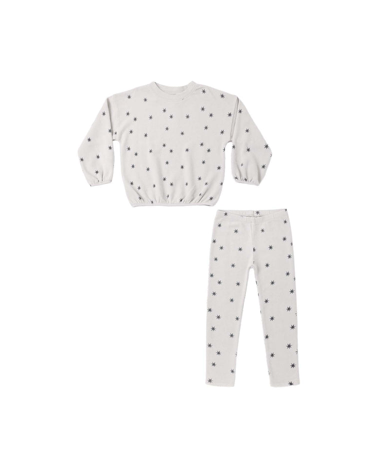 A matching set from rylee + cru, the PREORDER spongey knit set in stars features a long-sleeve pullover sweatshirt and snug leggings, both in white with a small black star pattern.