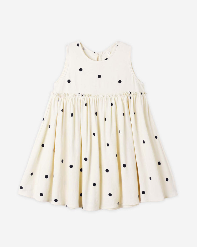 The harper dress in polka dot by rylee + cru is a sleeveless, knee-length babydoll tank dress for kids, crafted from white linen viscose with black polka dots and a gathered skirt. Shown on a plain white background. Pair with matching bloomers.