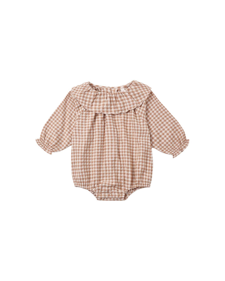The colette romper in fawn gingham by rylee + cru is a long-sleeve baby romper made from 100% cotton, showcasing a sweet pink and white gingham pattern with fawn accents. It features a ruffled collar, elasticized cuffs, and convenient bottom buttons for quick diaper changes—blending cozy comfort with delightful style.