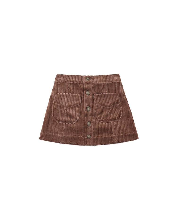The denver mini skirt in mulberry by rylee + cru, featuring front patch pockets and antique brass buttons, is displayed on a white background.