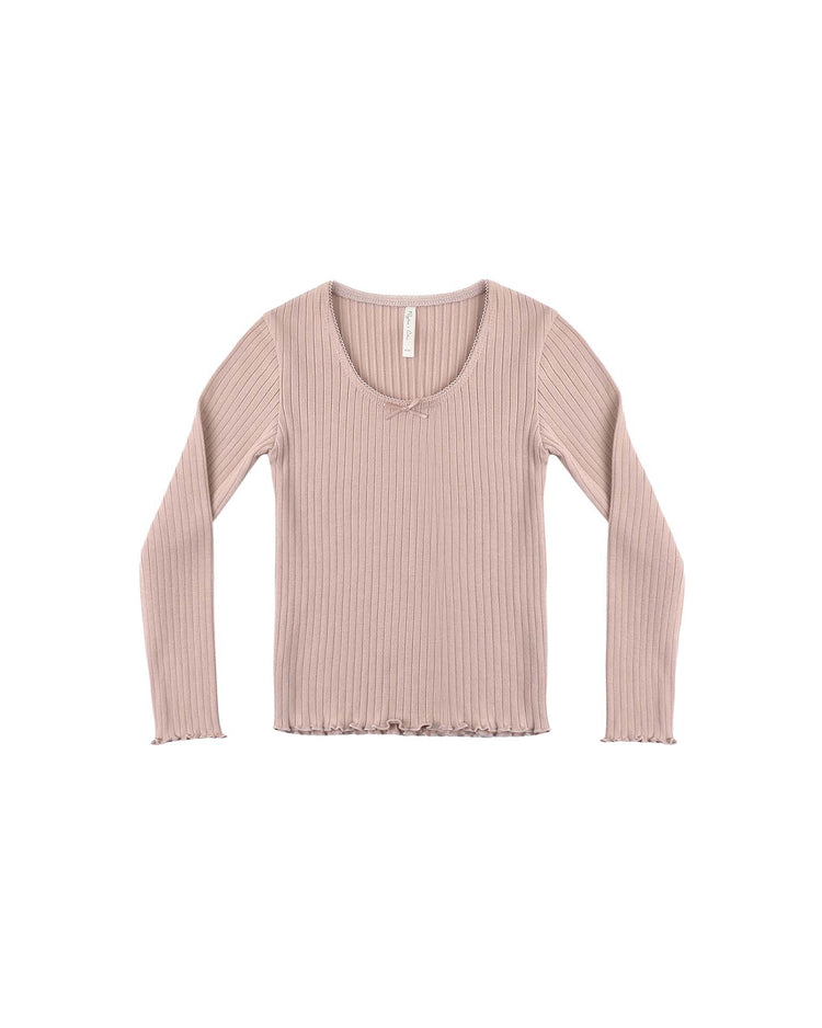 The rylee + cru ribbed long sleeve in rosewood features a light pink hue, scoop neckline with delicate lace trim, ribbed fabric, and subtle ruffle detailing at the hem and cuffs, shown laid flat on a white background.