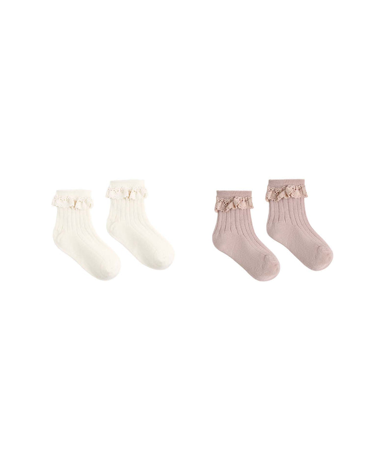 Two pairs of rylee + cru lace trim socks for children, one in natural and one in rosewood, each featuring delicate lace trim around the ankles, displayed on a white background.