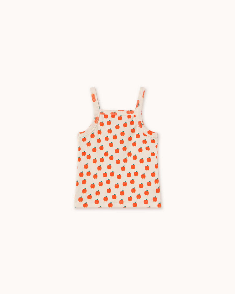 The "apples strap top in off-white" by tiny cottons features orange cherries with spaghetti straps, made from organic cotton for softness, laid flat on a plain background.
