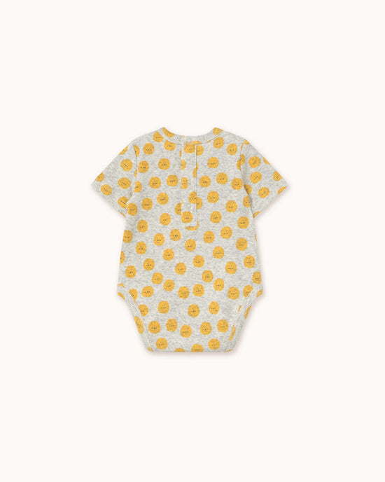 Light grey heather sun body by tiny cottons, featuring a unique yellow smiley face pattern, short sleeves, and convenient back buttons.