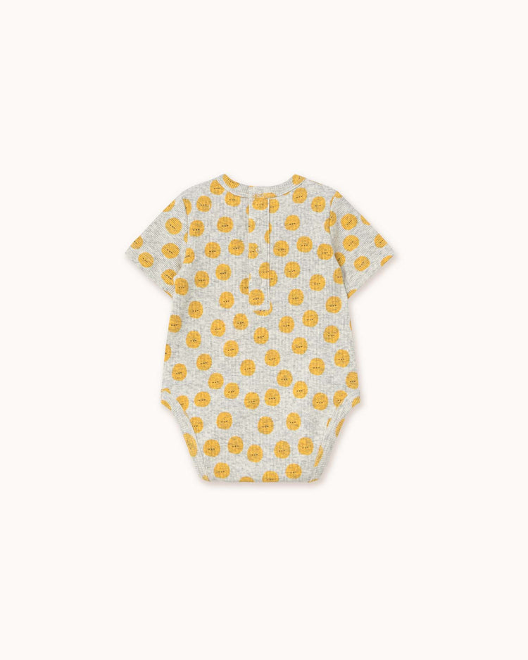 Light grey heather sun body by tiny cottons, featuring a unique yellow smiley face pattern, short sleeves, and convenient back buttons.