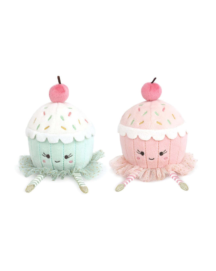 The mon ami Dancing Cupcake Duo includes two plush cupcakes—one blue, one pink—with smiling faces, striped legs, cherries, and sprinkles. A charming gift or playful decor for any room.