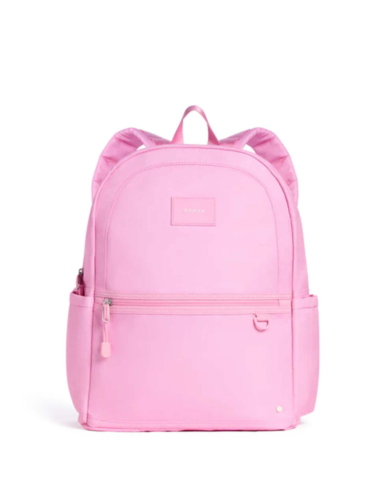Introducing the Kane Double Pocket Backpack in Pink by STATE Bags, featuring a top handle, two shoulder straps, dual front zipper pockets, and side pockets. Displayed against a plain white background, this stylish kids' school backpack is both functional and fashionable.