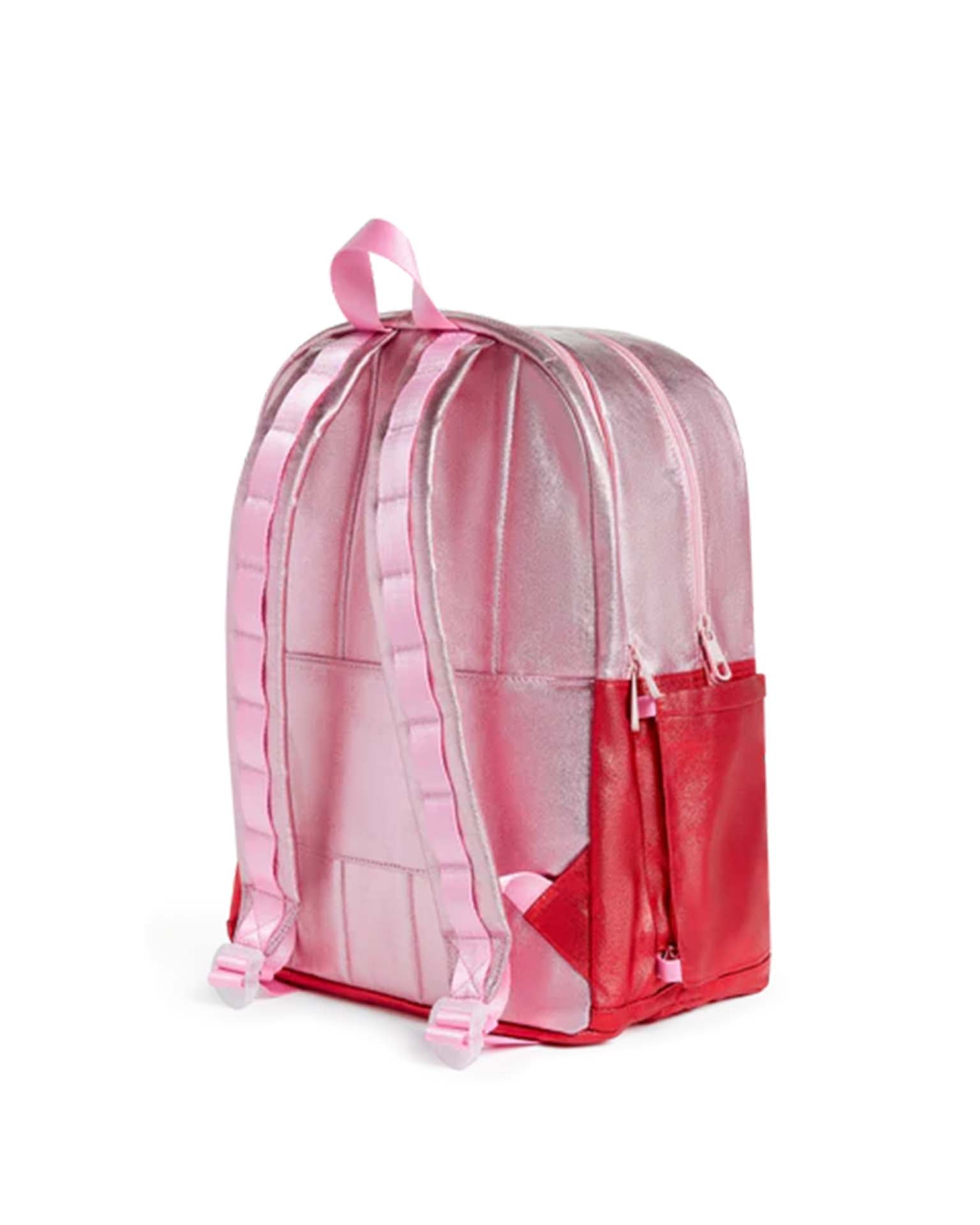 Introducing the State Bags Kane Double Pocket Backpack in Pink + Red Colorblock, featuring pink straps, a top handle, two zippered compartments, and a red side pocket—an eye-catching and stylish school backpack displayed on a white background.